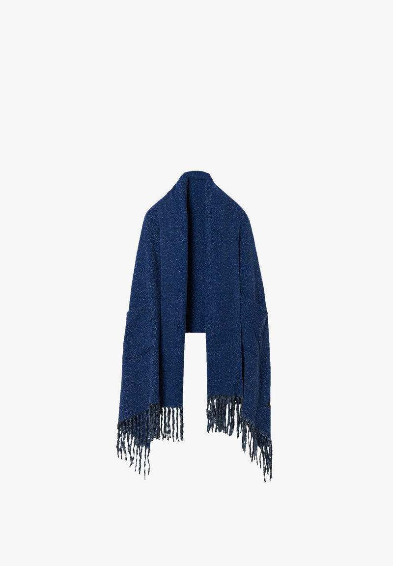Dark blue knitted shawl with a textured finish, featuring long fringes along the bottom and open sides. No fastenings, designed for layering.