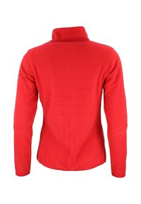 Veste en polaire rouge avec un col haut, des manches longues et une texture lisse. Présente un ourlet arrondi et un logo sur l'épaule gauche.