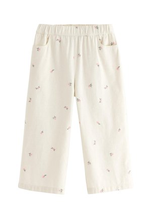 Pantalon beige clair en tissu doux, avec un imprimé floral rose et vert, doté d'une ceinture élastique et de poches latérales.