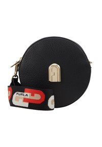 Borsa rotonda in pelle nera con superficie strutturata, logo in metallo dorato e tracolla in tessuto removibile con un audace motivo rosso e bianco.