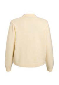 Cream-colored sweater with a soft texture, knitted fabric, and a ribbed hem. Features a classic round collar and dropped shoulder seams.
