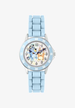 La montre avec bracelet en silicone bleu présente un cadran rond avec une lunette argentée. Le cadran affiche des personnages de dessin animé avec des indicateurs d'heure et de minute, sur un fond pastel.