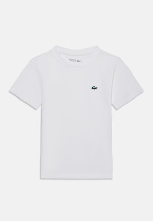 T-shirt blanc à manches courtes et col rond avec petit logo crocodile vert Lacoste sur la poitrine gauche.