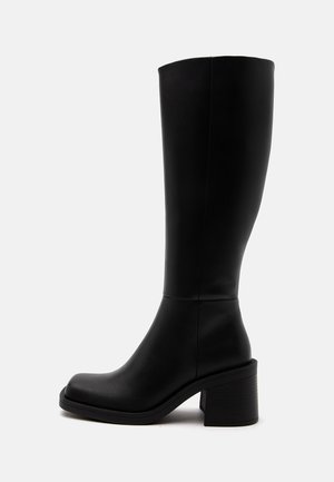 Black knee-high leather boot with block heel and rounded toe shown from the side on a plain light background.
