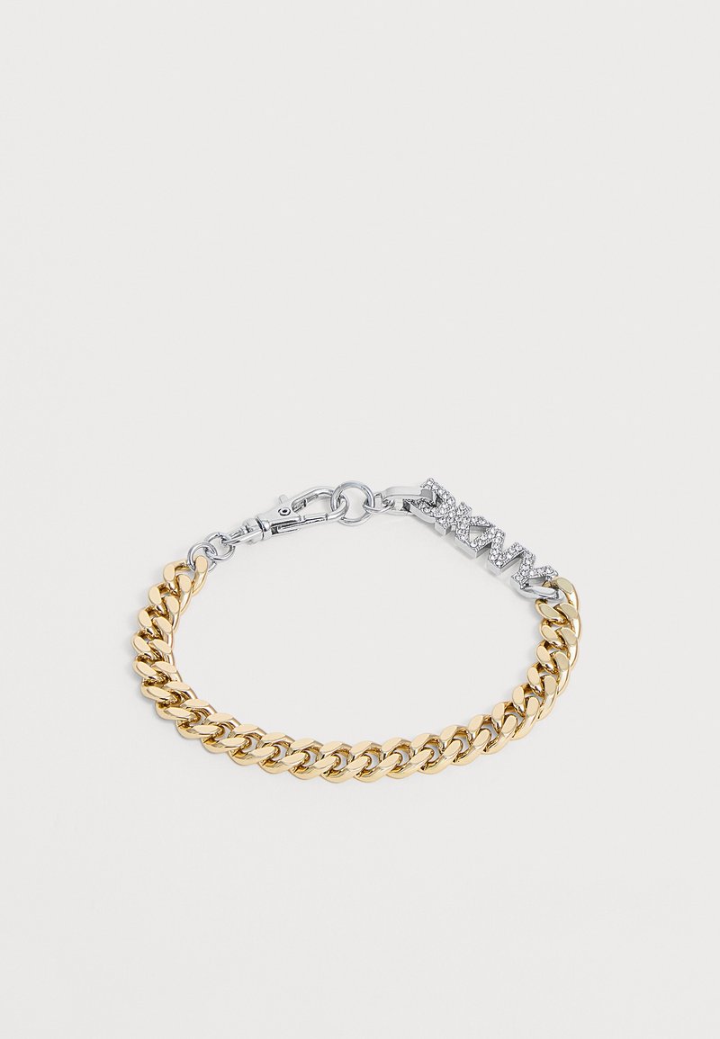 Bracelet chaîne ton or avec un charm en lettres "DKNY" ton argent incrusté de petits cristaux transparents et une fermeture à fermoir mousqueton.