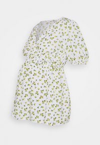 Robe blanche avec motif floral jaune, dotée de manches courtes bouffantes et d'une taille à cordon pour un ajustement réglable.