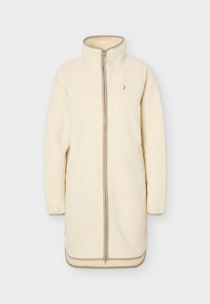 Μακρύ μπουφάν από φλις σε κρεμ απόχρωση με πλήρες φερμουάρ μπροστά, ψηλό γιακά, μακριά μανίκια και μπεζ διακόσμηση κατά μήκος των ακρών και του φερμουάρ.