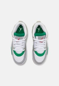 White athletic shoes with green accents and gray suede details. Features white laces, a padded collar, and a red logo on the tongue.