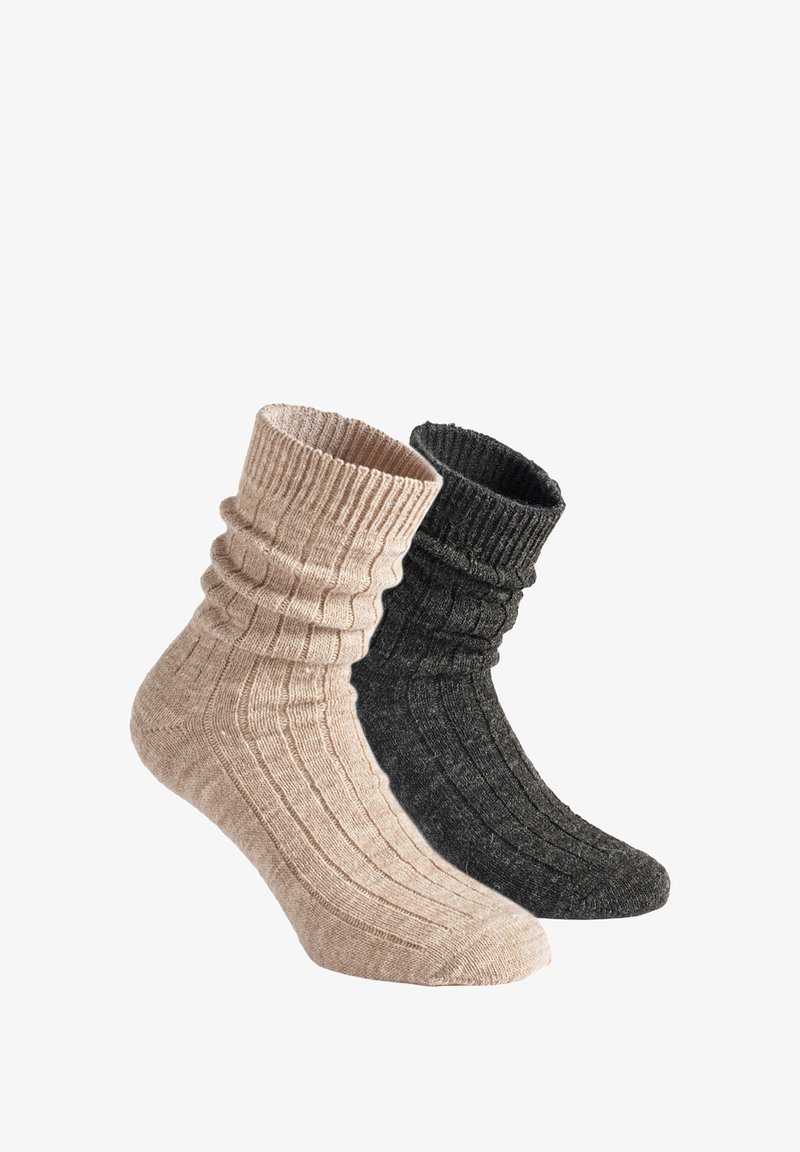Ribbed knitted socks in light beige and dark gray. Features a slouchy cuff, soft texture, and contrasting color patterns.