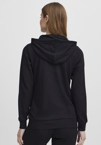 Black hoodie with long sleeves and a drawstring hood. Features a smooth texture and a fitted design. No visible patterns or accents.