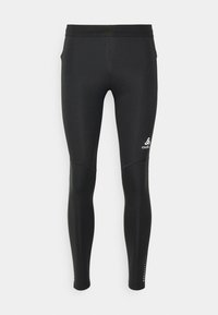 Black running tights made of stretchy, smooth material. Features a fitted design with subtle logo and perforated accents near the ankles.