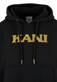 Čierna mikina s kapucňou obsahujúca veľké zlaté flitrované logo "KANI" na hrudi, s prednou vreckom a zlatými akcentmi na šnúrkach.