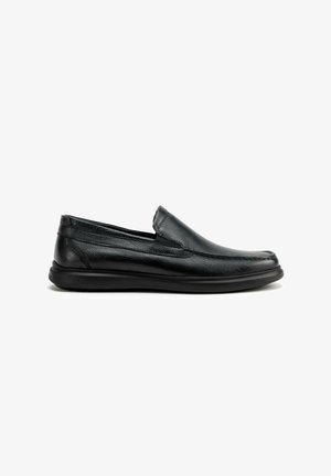 Zapatos negros de cuero sin cordones con acabado texturizado, punta redonda y paneles laterales elásticos; con suela flexible de goma negra.