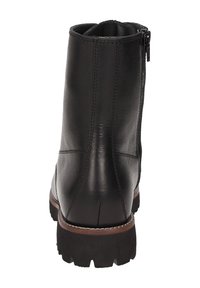 Stivale alla caviglia in pelle nera con finitura liscia, chiusura con zip laterale e suola in gomma resistente dotata di battistrada antiscivolo. Dettagli cuciti lungo i lati.