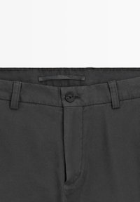 Gray pants with a flat front, single button closure, and belt loops. Made of a smooth fabric with a clean, tailored finish.