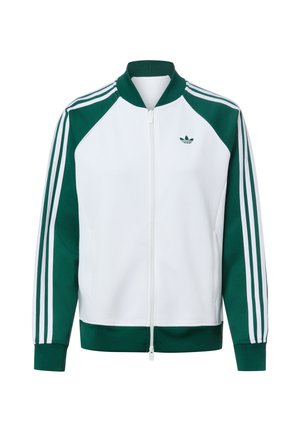 Biała i zielona sportowa kurtka zapinana na zamek z zielonymi rękawami, białymi paskami, prążkowanym kołnierzem, mankietami i logo Adidas trefoil na piersi.