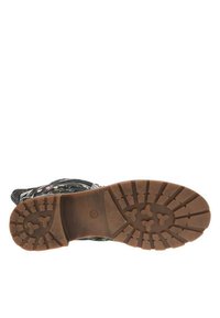 Botte noire à motif floral avec une semelle en caoutchouc brun robuste dotée d'un motif de crampons. La botte possède un dessus en tissu avec des accents colorés.