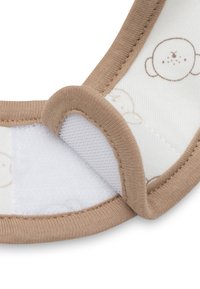 Witte babykraag van katoen met lichtbruine rand. Kenmerkt een speels apenpatroon en een zachte klittenbandsluiting voor gemakkelijke aanpassing.