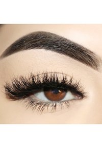 Close-up of an eye with long, thick black eyelashes and well-defined dark brow. The iris is brown with a hint of light reflection.