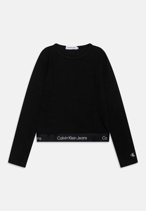 Zwarte cropped lange mouwen top van ribmateriaal, met een ronde halslijn en een elastische band met het "Calvin Klein Jeans" logo aan de onderkant en op de mouw.