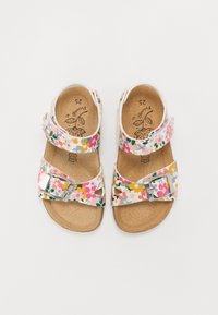 Floral patterned sandals with a cork footbed, adjustable straps, and metal buckle. Dominant colors include pink, yellow, and green accents. Size 25.