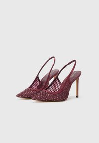 Burgundske slingback pete s koničastimi prsti, ki imajo mrežno prevleko okrašeno s svetlečimi dodatki in tankimi stiletto petami.