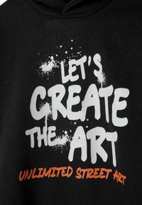 Black hoodie featuring bold white and orange text: "LET'S CREATE THE ART" with a spray paint effect and splatter details.