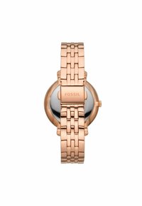 Montre bracelet en métal rose gold avec un cadran rond et un dos en acier inoxydable poli. Dispose d'un fermoir à charnière avec le logo "FOSSIL" sur le bracelet.