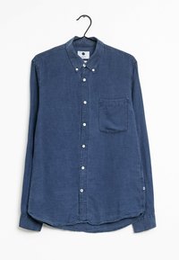 Chemise boutonnée bleue avec une poche poitrine, manches longues et ourlet arrondi. Fabriquée en coton texturé. Dotée de boutons blancs.