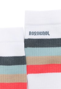 Calcetines a rayas en blanco, gris, azul turquesa, beige y coral con textura acanalada; presenta el logo "Rossignol" en el puño.