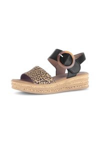 Leopard print and black leather sandals with a round, transparent ring accent. Features a wedge sole with layered texture. Adjustable strap.