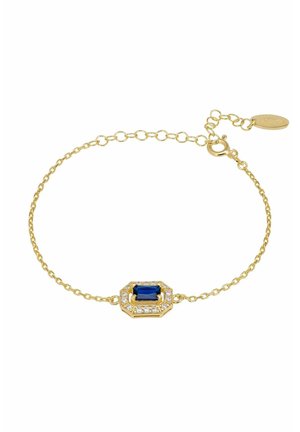 Finom arany láncos karkötő, közepén téglalap alakú kék drágakővel, melyet kis tiszta kristályok vesznek körül, állítható kapoccsal és címkével.