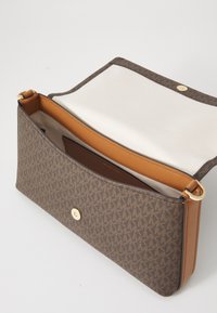 Brown patterned bag with a smooth tan leather trim. Features a gold snap closure and beige fabric lining, designed for easy access.