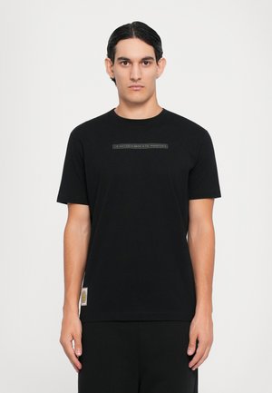 Black t-shirt in soft cotton, featuring short sleeves and a crew neck. Centered text graphic across the chest, with a brand label at the hem.