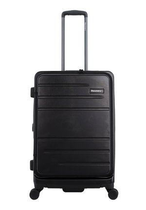 Black hard-shell suitcase with horizontal grooves, retractable handle, top and side carry handles, and four wheels for mobility.