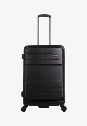 Black hard-shell suitcase with horizontal grooves, retractable handle, top and side carry handles, and four wheels for mobility.