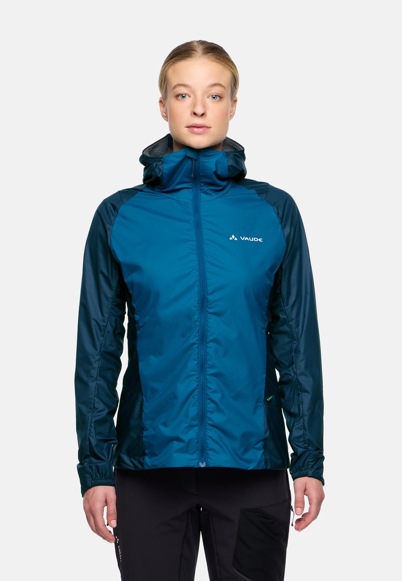 Veste imperméable teal avec capuche, fermeture éclair sur le devant et poignets élastiques. Texture lisse et poches latérales, avec un logo visible sur la poitrine.