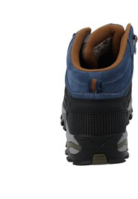 Blue suede hiking boot with a brown cushioned collar, textured black midsole, and a rugged rubber sole featuring prominent treads.
