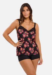 Black floral camisole with pink and green flowers, featuring a lace trim and adjustable straps, paired with black shorts.