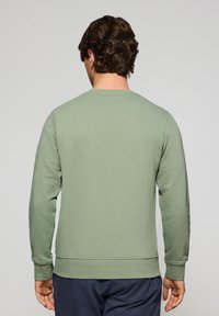 Grön sweatshirt i bomullsblandning med rund hals, långa ärmar, ribbade muddarna och en strukturerad yta, sedd bakifrån.