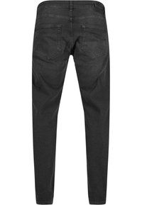 Jean noir coupe slim vu de dos avec deux poches arrière et une fermeture par bouton à la taille.