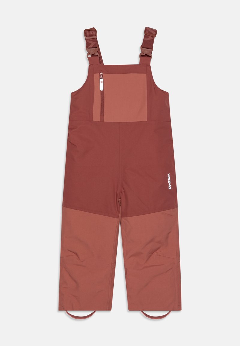 Pantalon-bavoir imperméable bicolore brun rouille pour enfants avec bretelles réglables, poche poitrine zippée à l'avant et sangles élastiques pour les pieds.