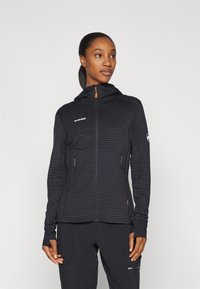 Black hooded jacket with ribbed texture and front zipper. Features two side pockets, thumbholes, and contrasting orange accents.