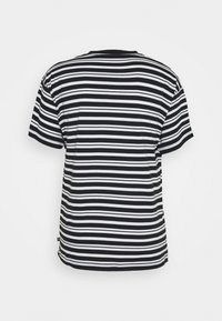 Black and white striped t-shirt with short sleeves, round neckline, relaxed fit, and visible stitching along the hem and sleeves.