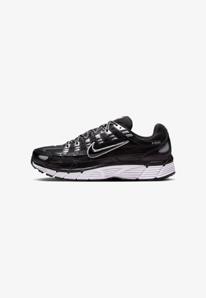 Black mesh athletic shoes with white sole, featuring a textured design, reflective accents, and multiple overlay straps for support.