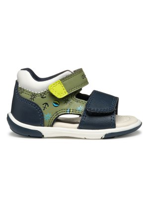 Sandalia infantil en azul marino y verde oliva con suela blanca, diseños náuticos azules y dos correas ajustables con velcro.