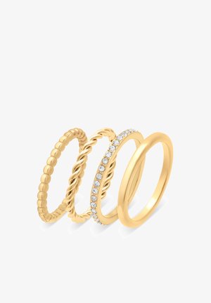 Ensemble de quatre bagues en or : une avec une texture de perles, une avec un design torsadé, une ornée de pierres claires, et une simple alliance.