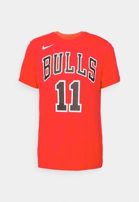Red short-sleeve t-shirt made of cotton with “BULLS” in black lettering and number “11” in a textured print on the front. Nike logo on shoulder.