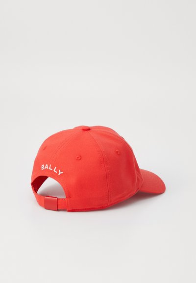 Casquette en coton rouge avec visière incurvée, affichant le logo blanc "BALLY" à l'arrière, fermeture à réglage et six œillets de ventilation.
