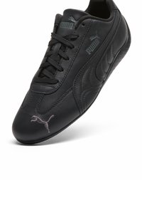 Baskets en cuir noir Puma avec lacets, design cousu et logo Puma sur l’orteil, le côté et la languette.
